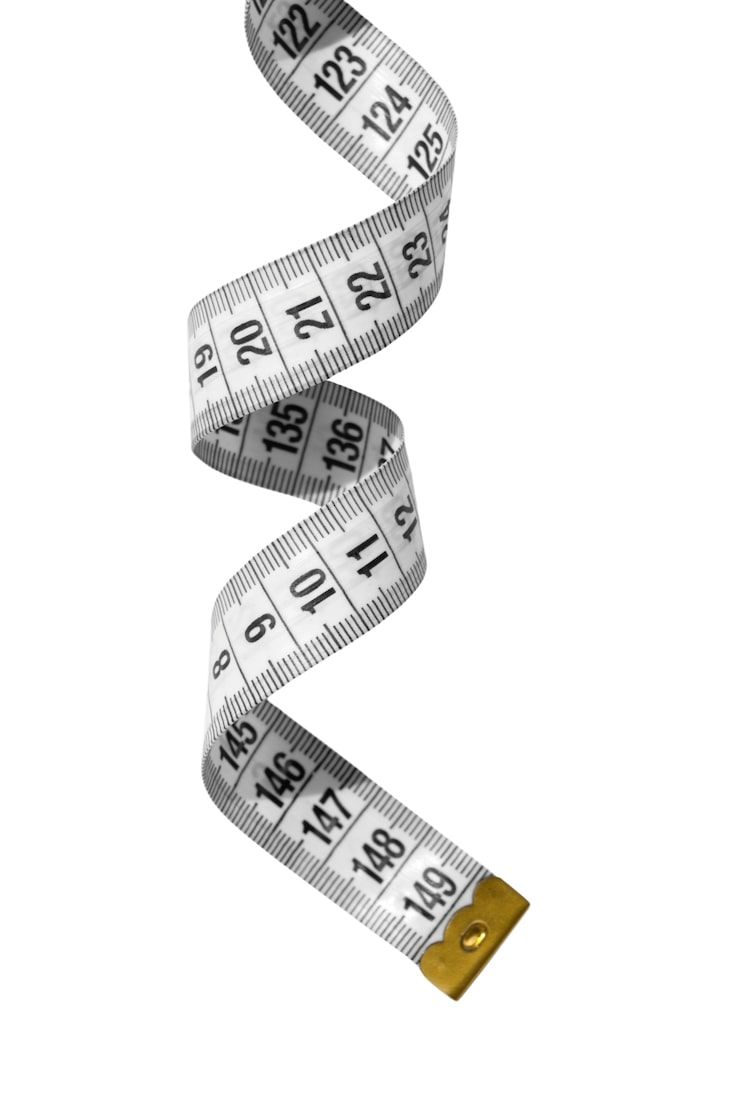 A measuring tape curled into a spiral